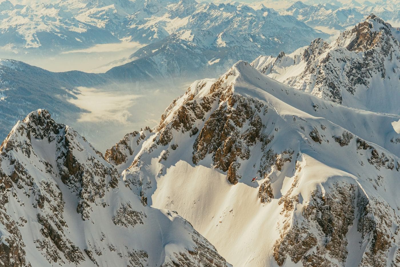 Sharp snow-covered summits with valleys of cloud below, in the mountains at St Anton am Arlberg